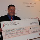 John Oldham donating £1000 cheque